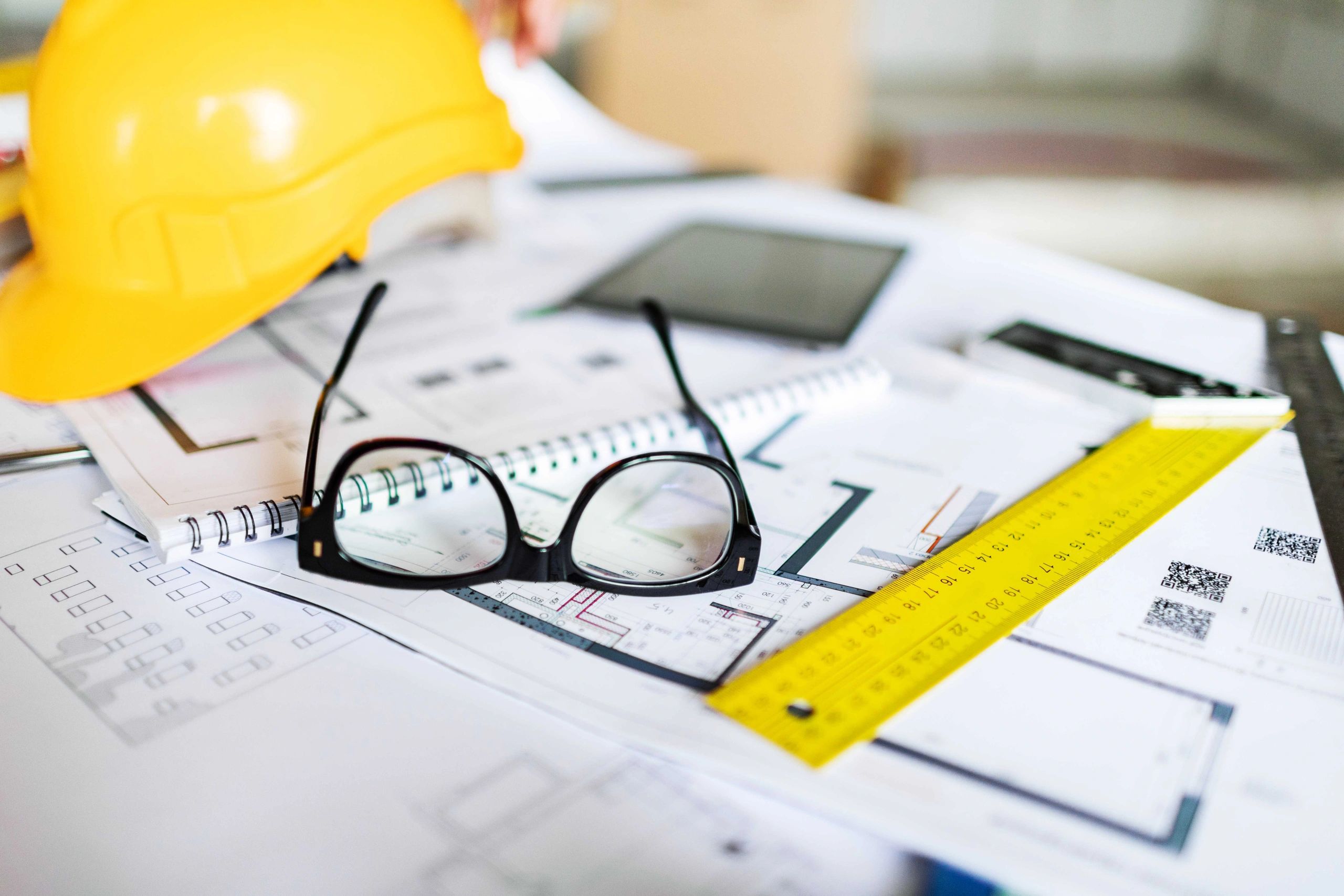 Blueprints and planning tools on a project desk