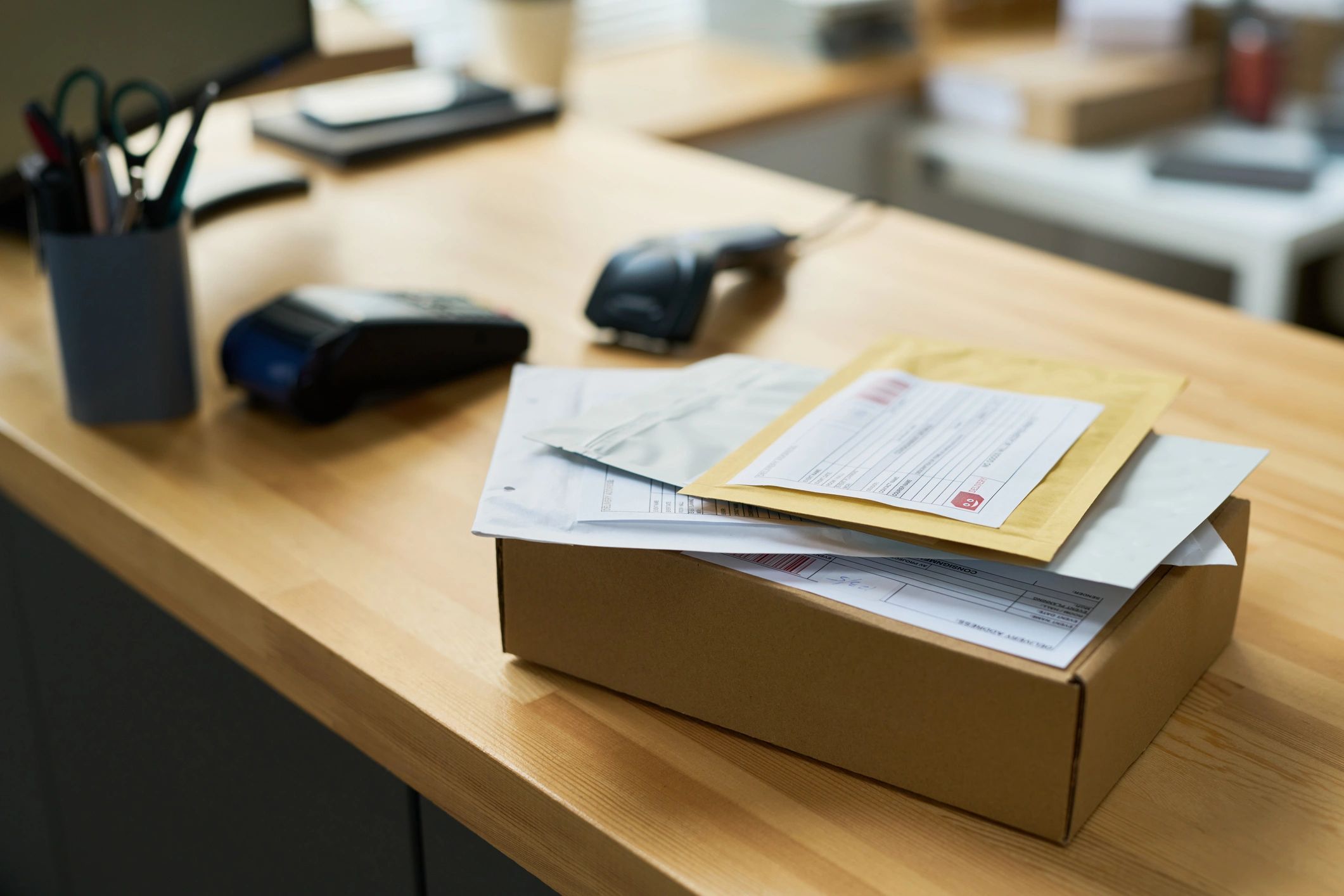 Parcels and documents on an office desk ready for processing