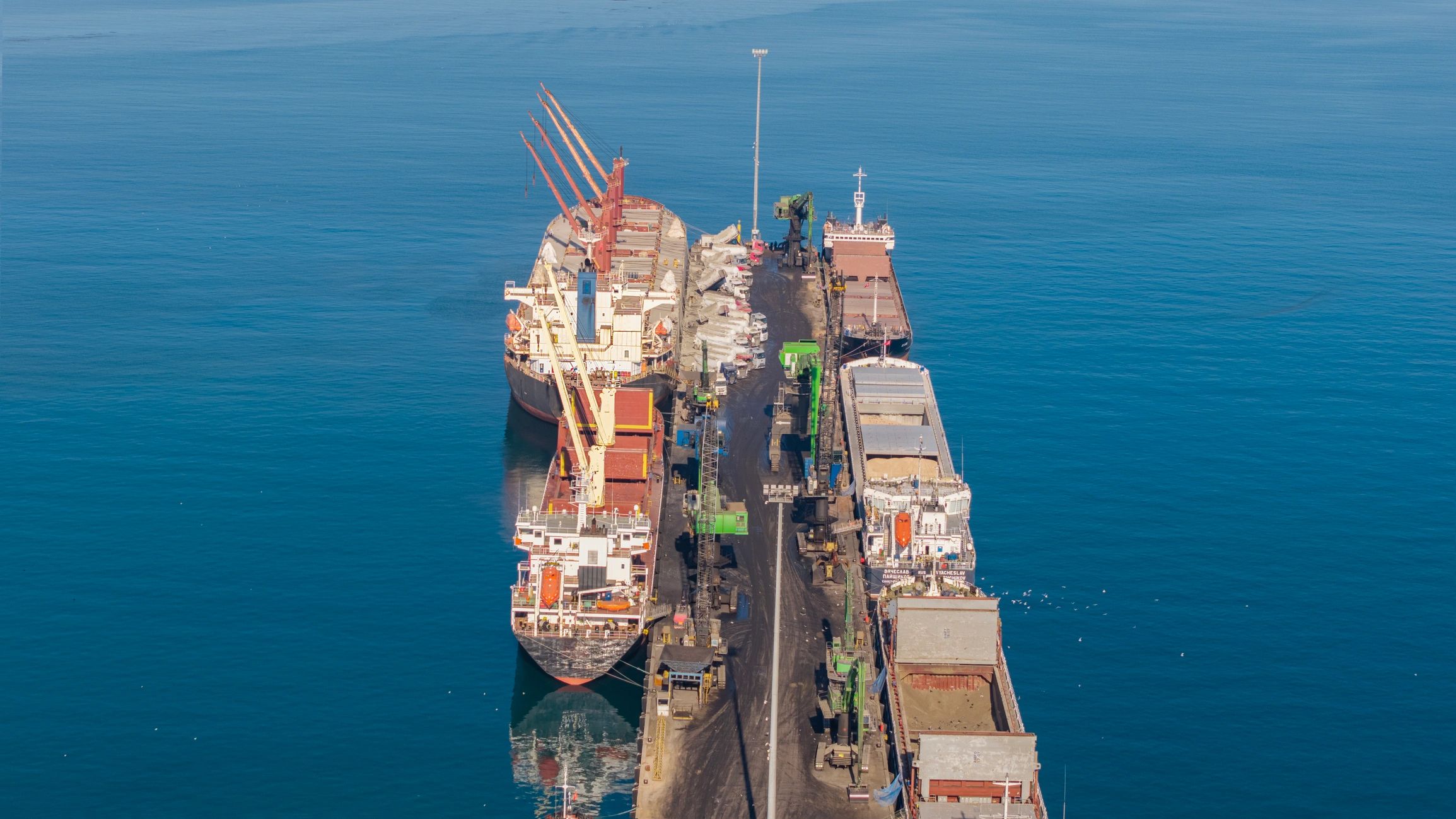 Aerial view of cargo ships docked at an industrial port