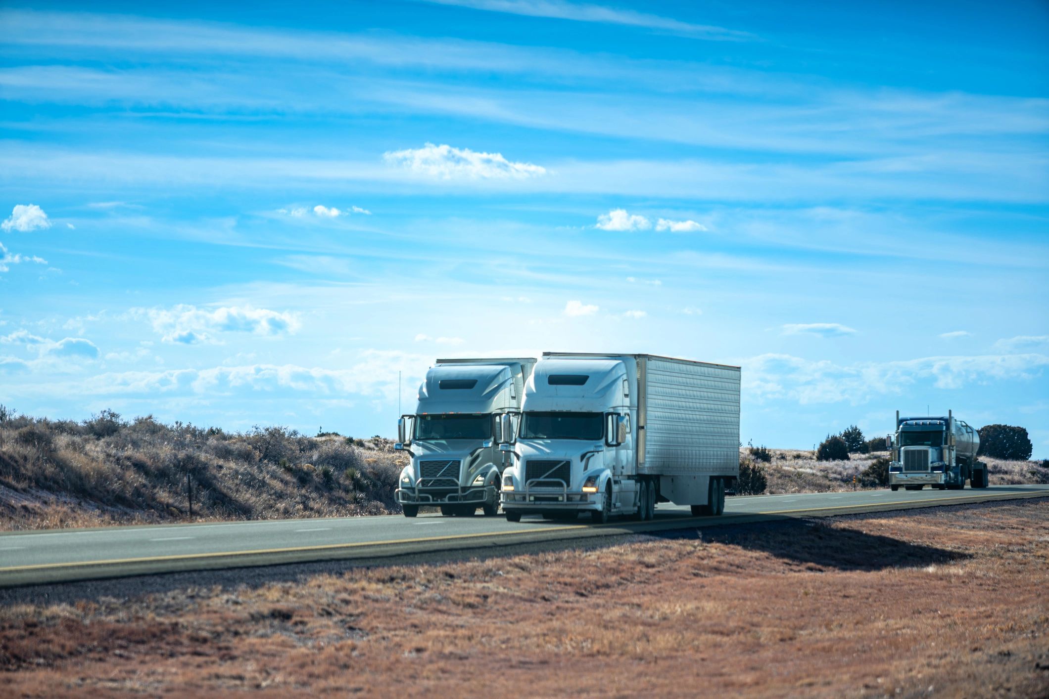 Semi-trucks parked on a highway rest area
